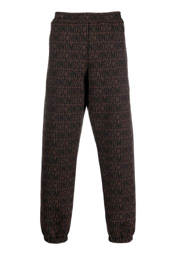 Moschino Pantaloni sportivi con logo all-over - Marrone