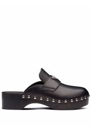 Prada triangle logo studded clogs - Nero