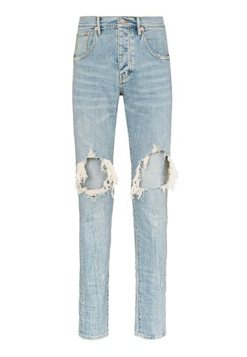 Jeans slim con strappi