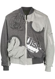 Undercoverism reversible logo-print bomber jacket - Grigio