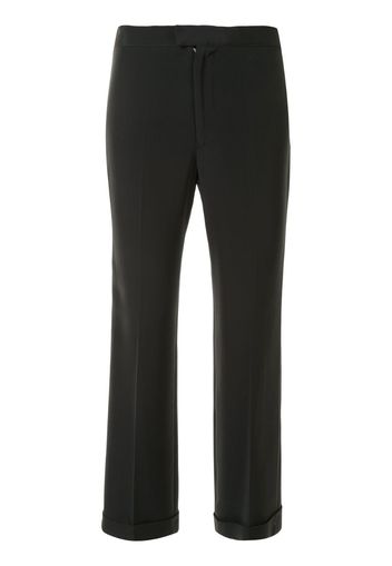 Pantaloni slim con pieghe