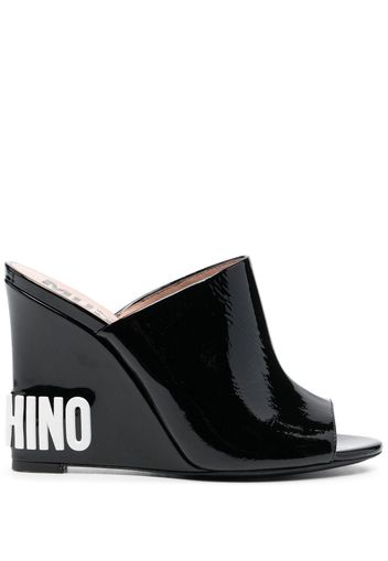 Moschino embossed-logo wedge mules - Black