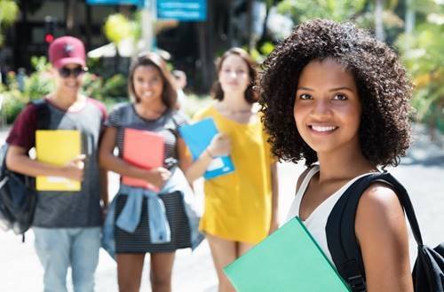 Beyond Scholarship Reminder. Students standing outside.