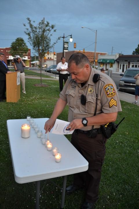 Marion County Sgt. Bill Pendley lighting a candle.