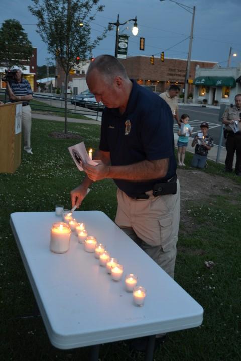 Winfield Chief of Police Robert Blaylock lighting a candle.