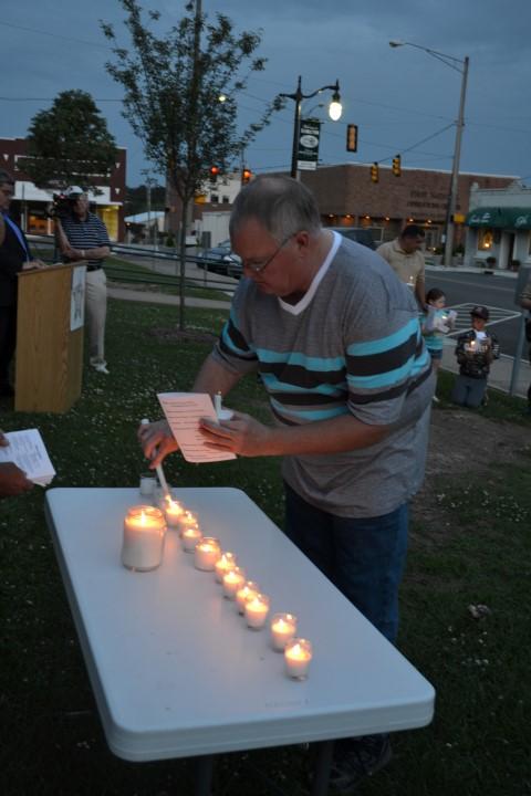 Winfield PD Officer Jeff Hughes lighting a candle.