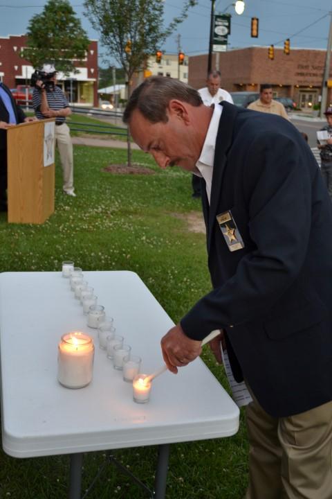 Marion County Sheriff Kevin Williams lighting a candle.