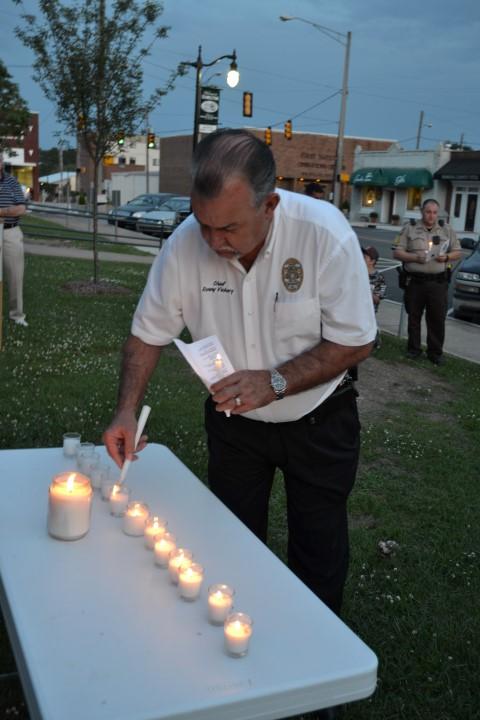 Hamilton Chief of Police Ronny Vickery lighting a candle.