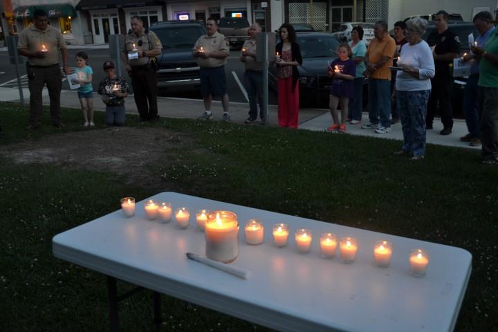 Table with the lit candles for the vigil.