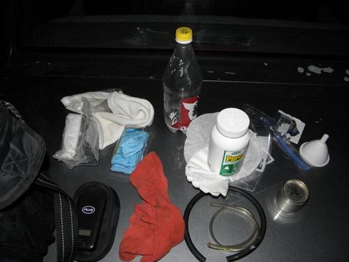 The contents that were in the lunchbox cooler now spread out for display on a vehicle hood.