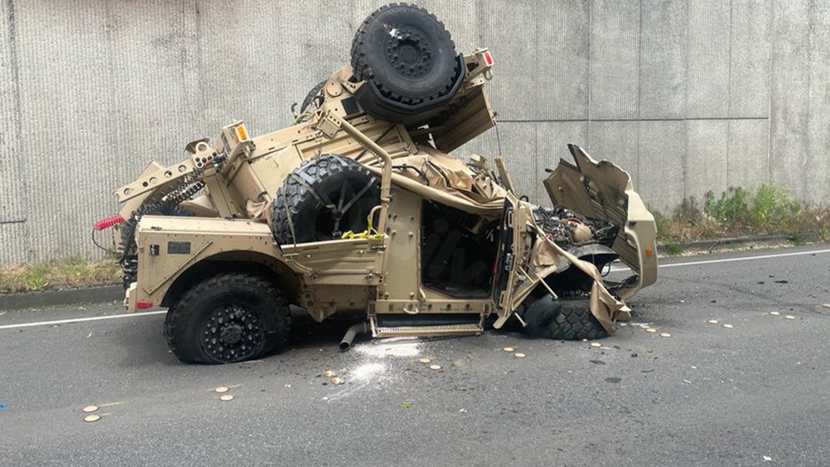 Military vehicle crashes over highway wall, injuring two and falling 30 feet onto road