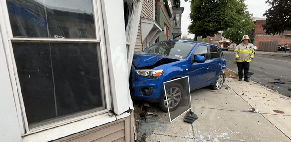 Car crashes into home in Troy
