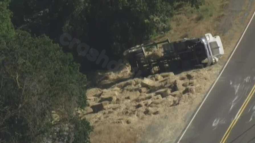 Truck carrying hay crashes, overturns in Yolo County