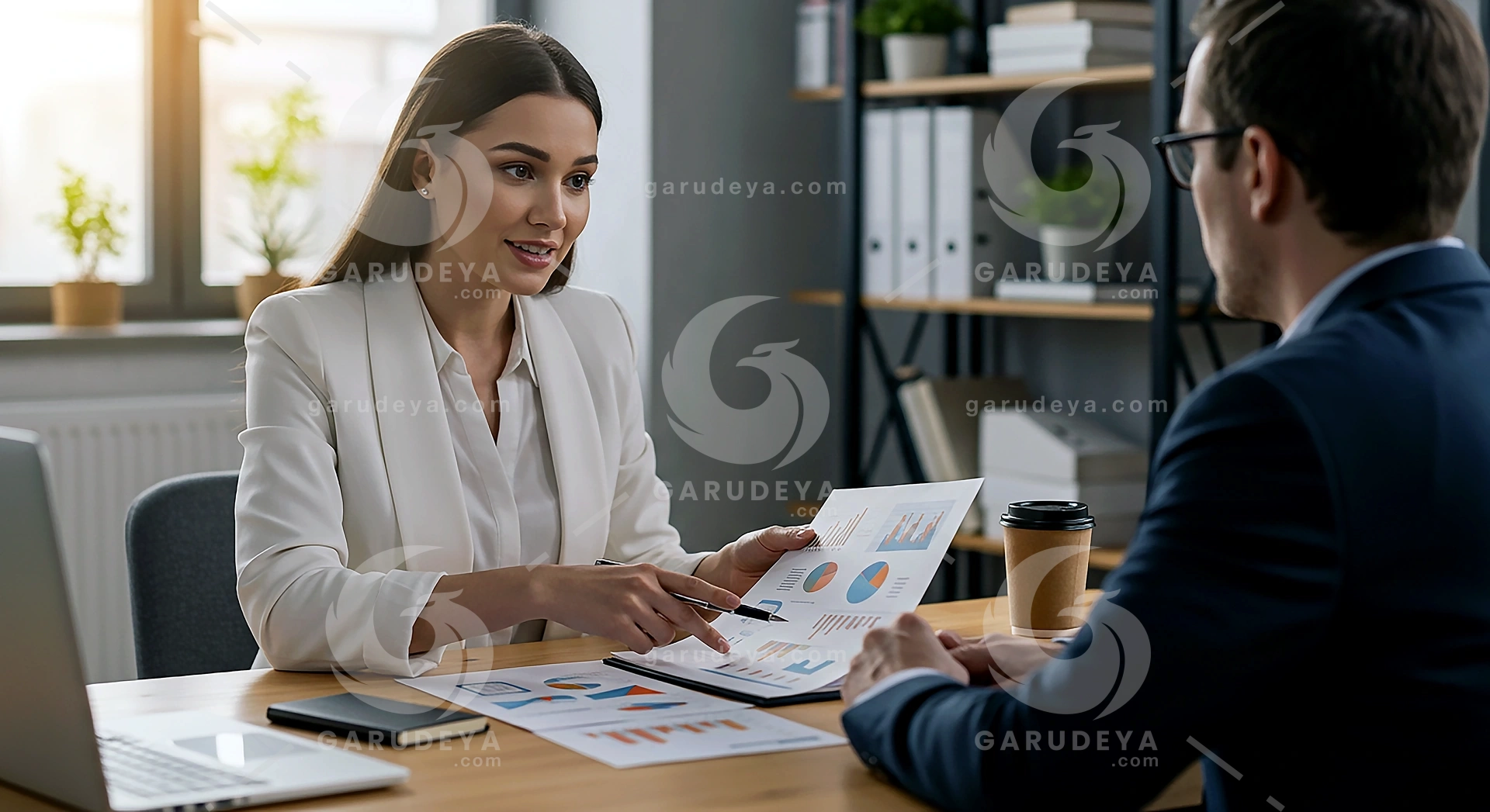 Female Financial Advisor Consulting Client with Investment Portfolio Charts in Office