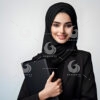 a beautiful young Arab female secretary dressed formally in black and wearing a hijab with a friendly expression and smile carrying a file-75432