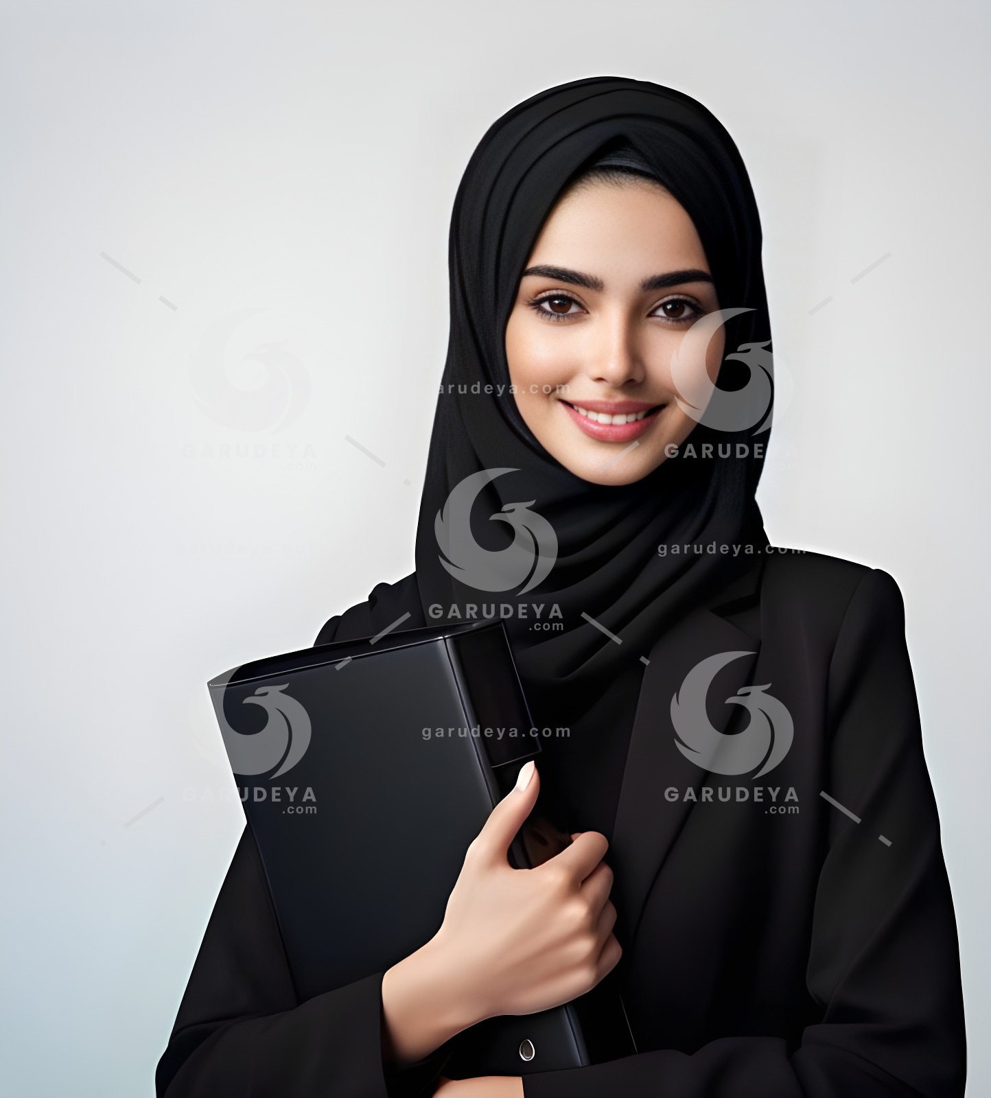 A beautiful young Arab female secretary dressed formally in black and wearing a hijab with a friendly expression and smile carrying a file-75432