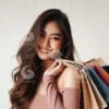 beautiful young Indonesian woman carrying lots of shopping bags with a cheerful expression-0108287