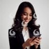 beautiful young Indonesian woman in formal clothes, looking at a cellphone screen with a cheerful expression-525897520