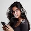 beautiful young Indonesian woman looking at a cellphone screen-31502935