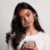 beautiful young Indonesian woman looking at a cellphone screen-621642