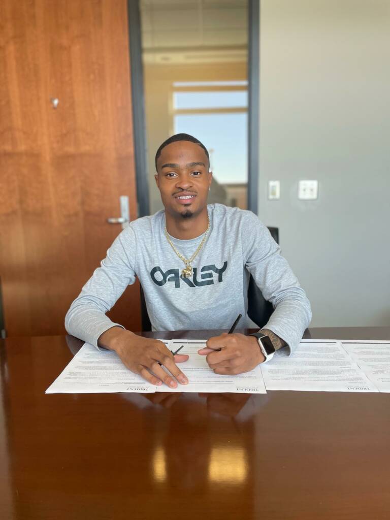 Quincy Hall signing professional contract.