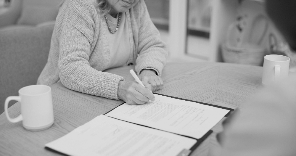image of lady signing papers
