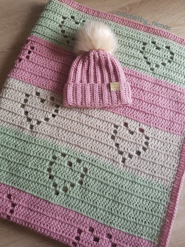 Crocheted Love heart blanket with pom pom beanie hat. - main product image