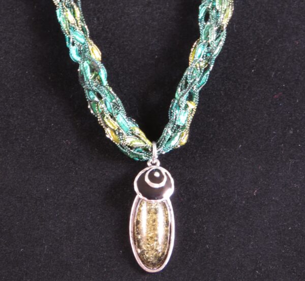 Green necklace with green and black pendant - main product image