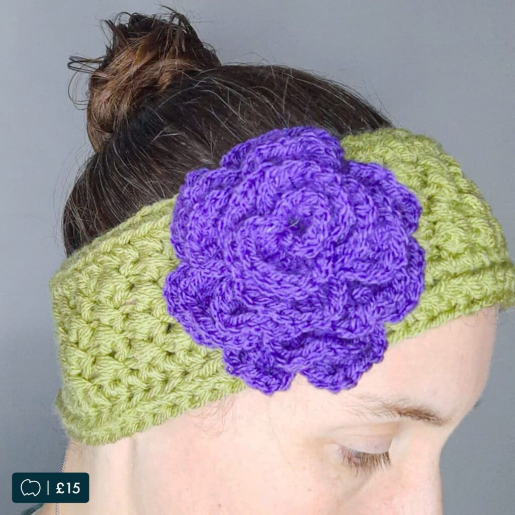 Crochet ear warmer with decorative rose