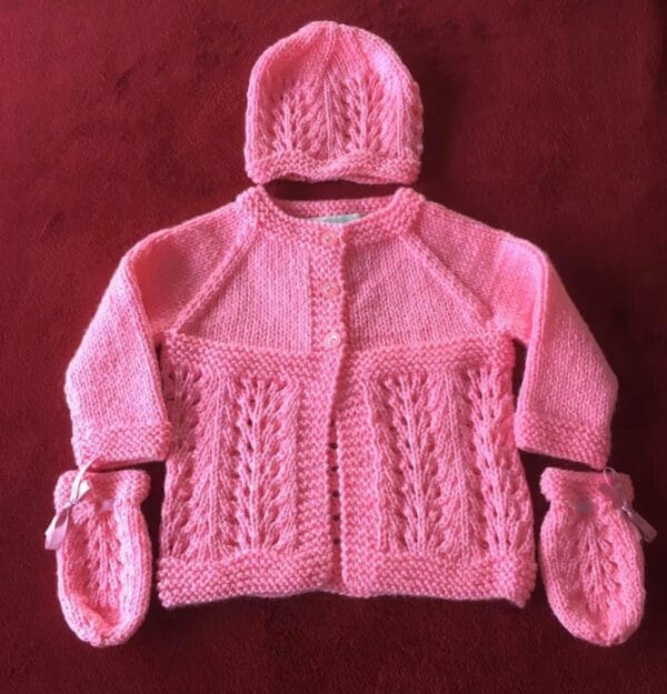 Hand knitted baby outfit in bubblegum pink - main product image