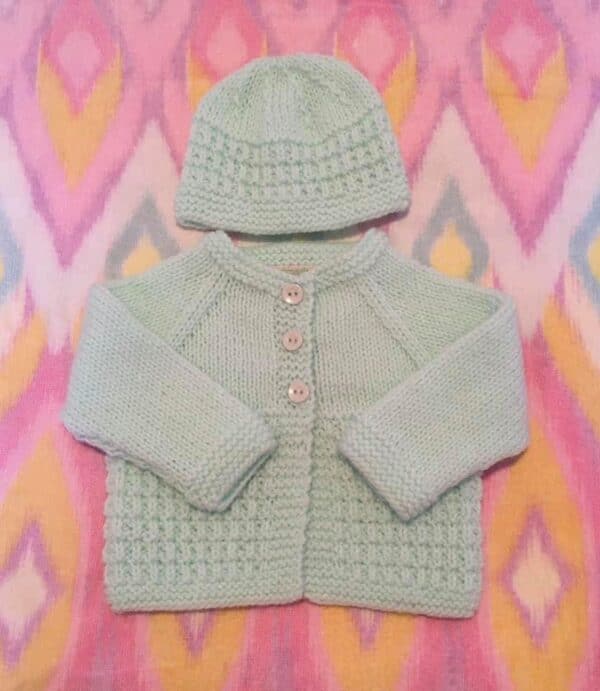 Hand knitted baby outfit in apple green - main product image