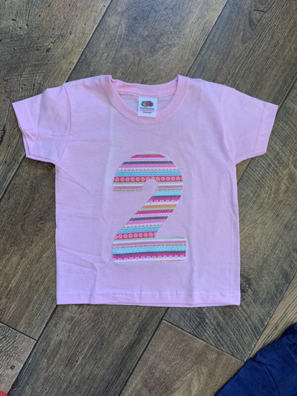 ON SALE Age 2 appliqué birthday t-shirt. Pink with decorative stripe print - main product image