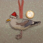 Seagull wearing Santa hat hanging decoration . gift tag