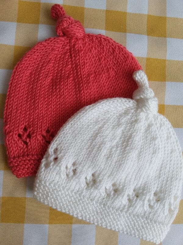 Hand knitted lace border baby top knot hat - main product image