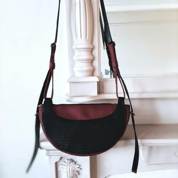 Artisanal crossbody handmade high-end black and burgundy half moon bag. - main product image