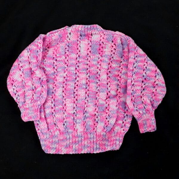 Hand knitted baby jumper in purples and pinks 6 – 12 months - product image 4