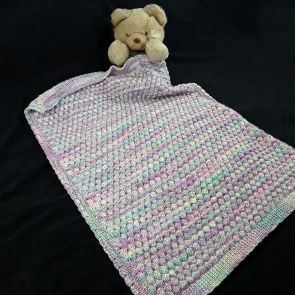 Hand knitted baby multicoloured bobble pram blanket – lilac, pink, green - main product image