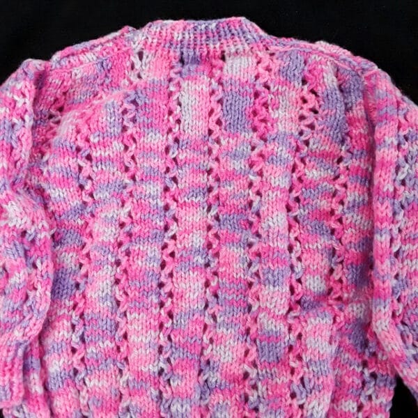 Hand knitted baby jumper in purples and pinks 6 – 12 months - product image 5