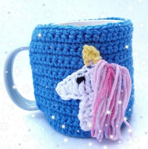 Blue unicorn lovers hand crocheted mug cosy with white unicorn with pink and blue sparky mane - main product image