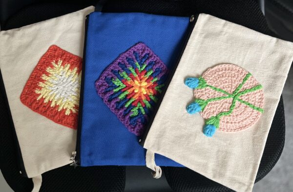 Cotton canvas clutch bags with crochet appliques - main product image