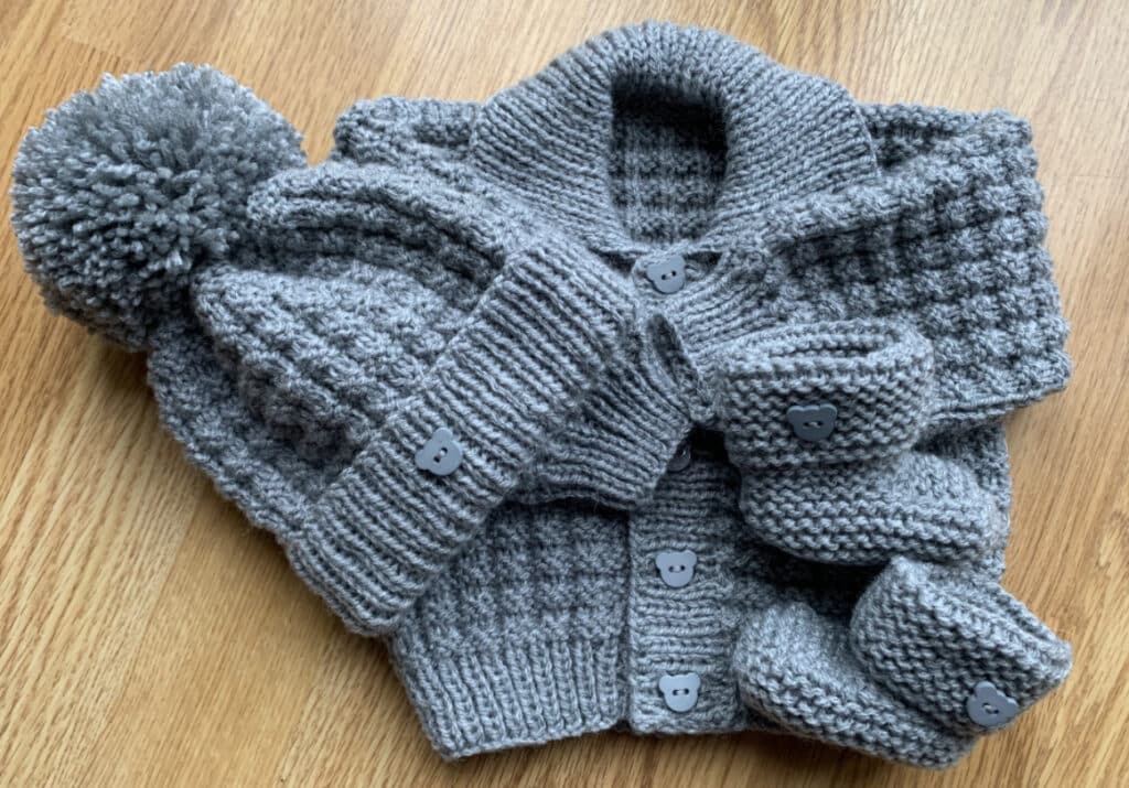 Hand knitted baby cardigan, hat and booties