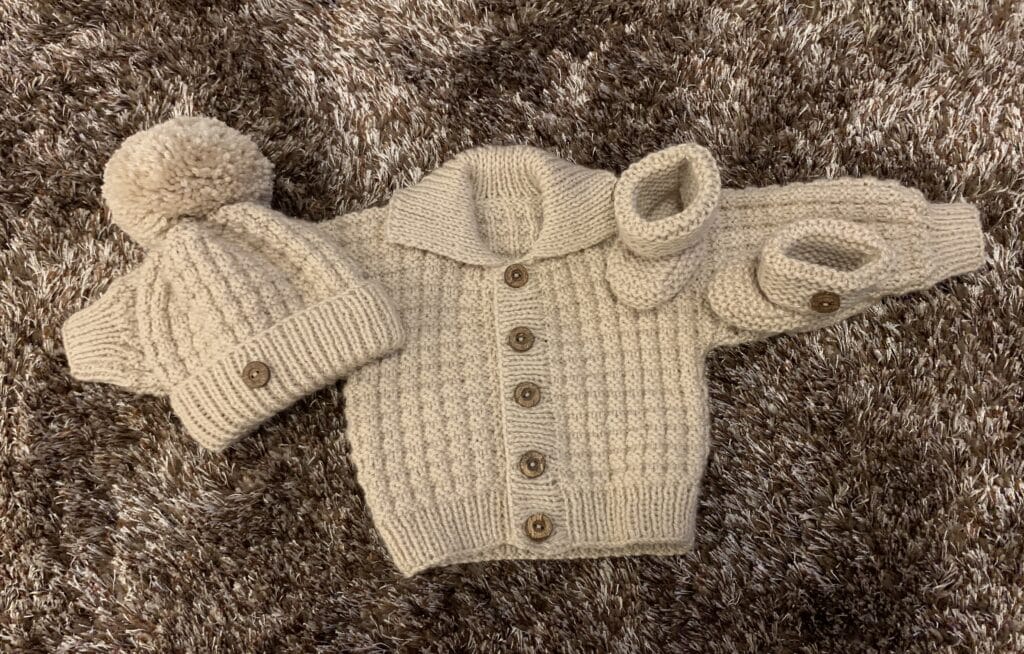 Hand knitted baby cardigan, hat and booties