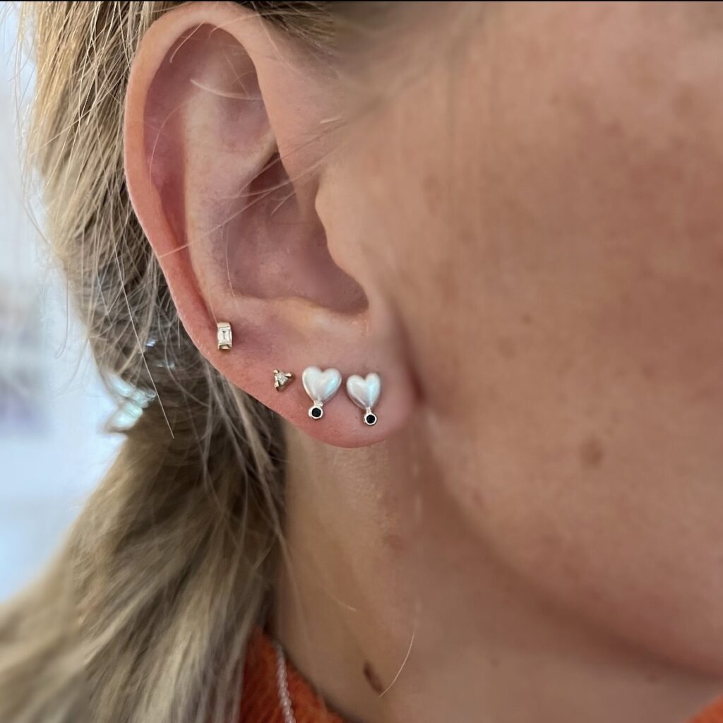 Sterling silver heart shape ear stud with natural black sapphire