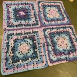 Ladies poncho in blues and purples with fringe detail