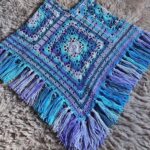 Ladies poncho in blues and purples with fringe detail