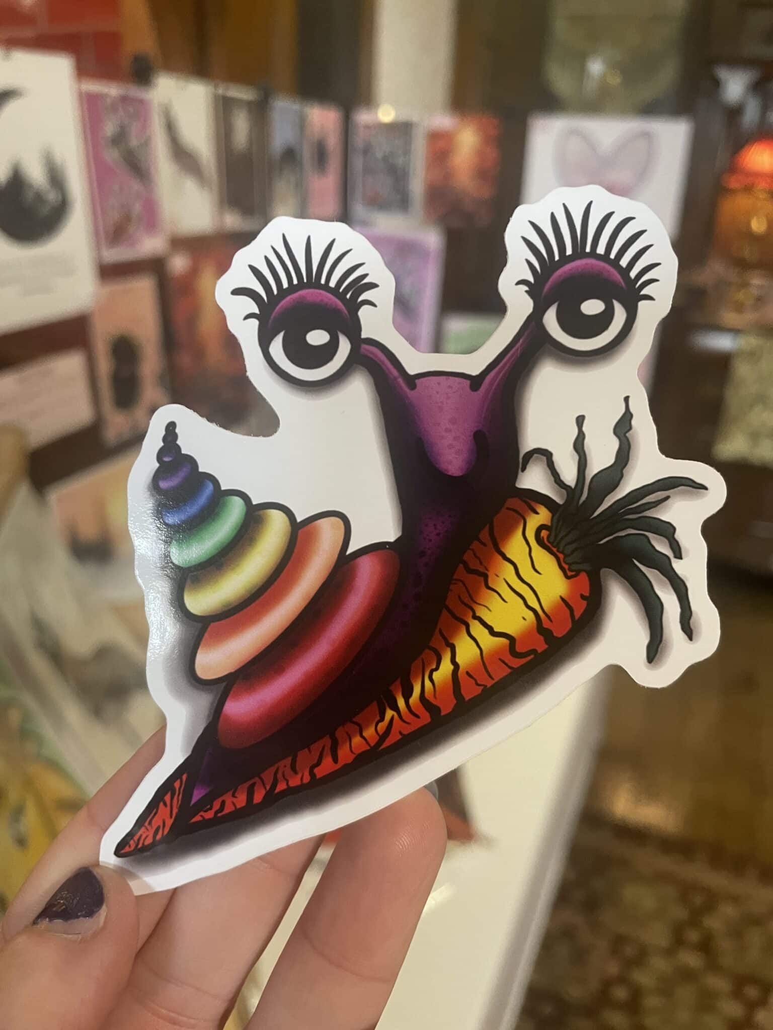 Psychedelic Snail riding a carrot Cartoon Sticker - main product image