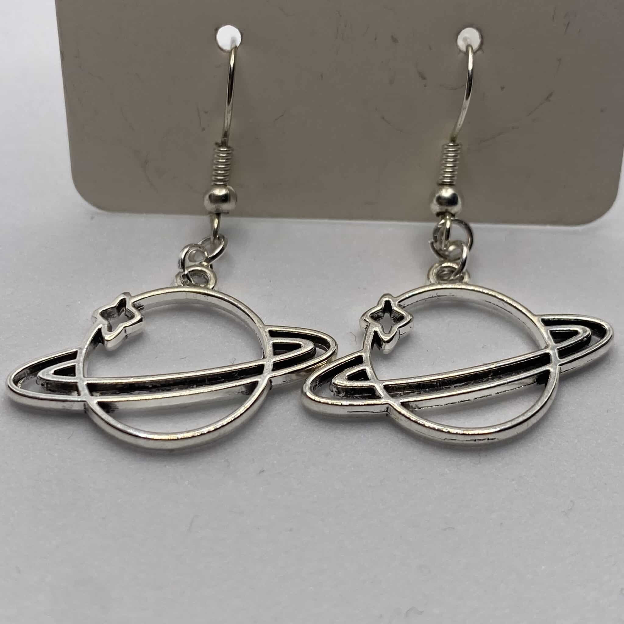 Silver coloured space solar system Saturn drop earrings - main product image