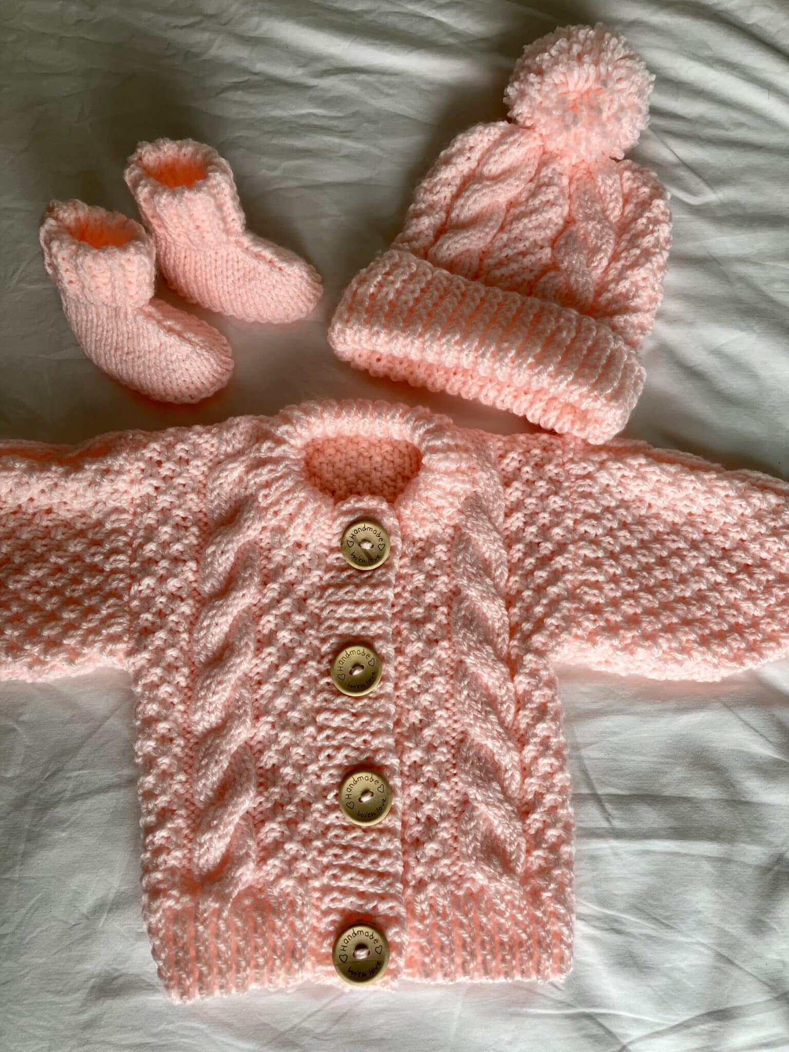 Girls pink Aran cardigan, hat and bootees set - main product image