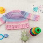 Hand knitted baby girls pink and lilac cardigan