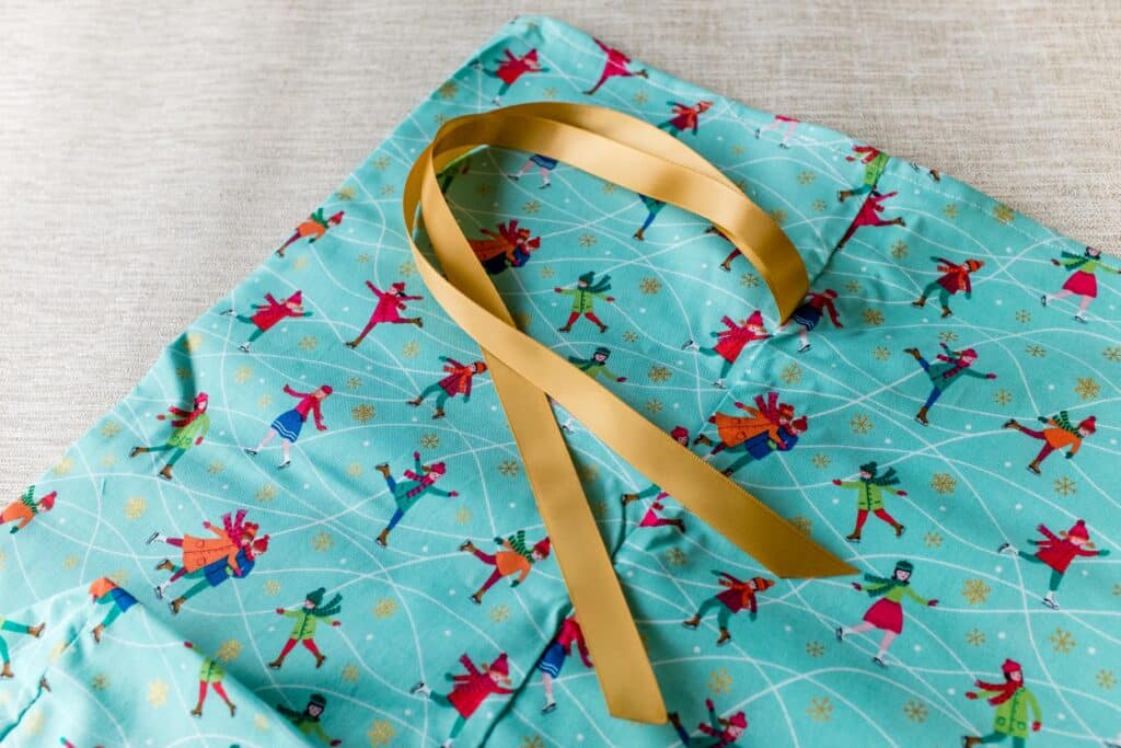 Reusable Fabric gift bag for winter and Christmas, ice skaters on cool blue